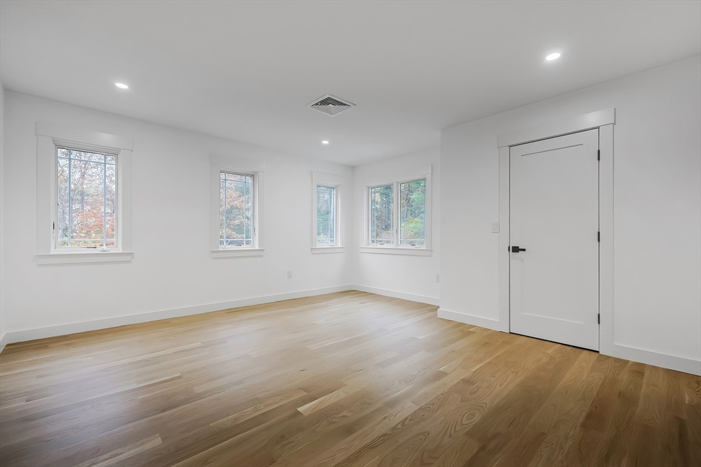 54 Spywood Road Sherborn, MA 01770 - Photo 29 of 41 a view of an empty room with wooden floor and a window