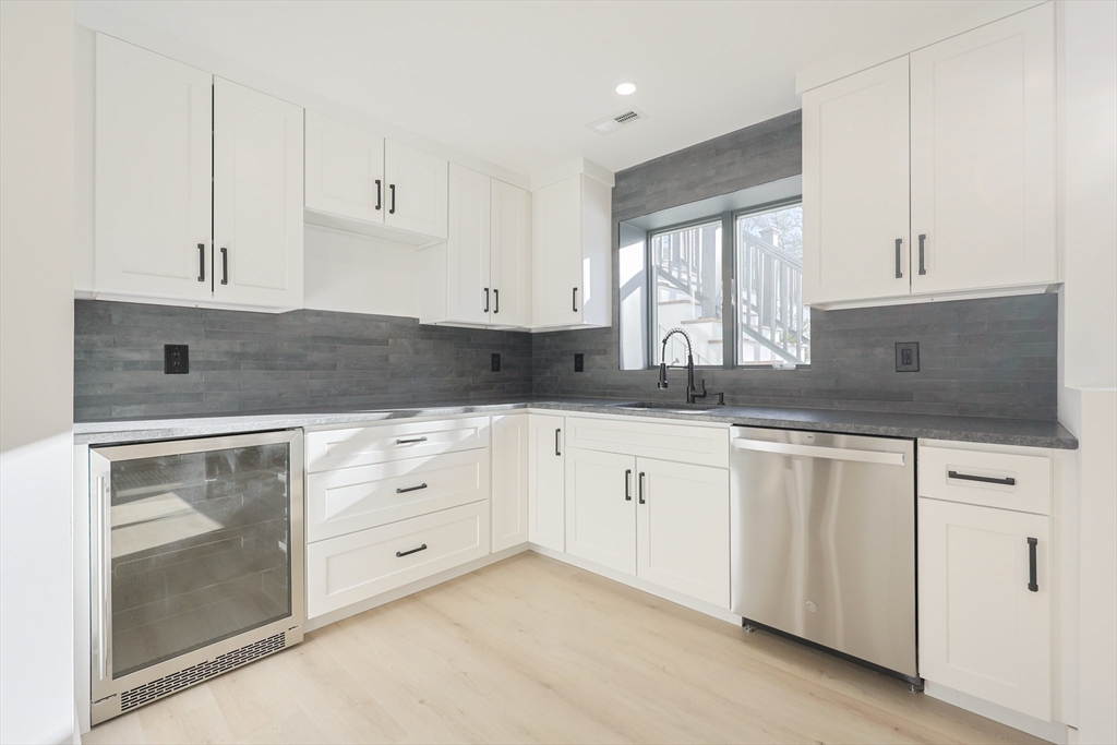54 Spywood Road Sherborn, MA 01770 - Photo 36 of 41 a kitchen with granite countertop white cabinets white stainless steel appliances and sink