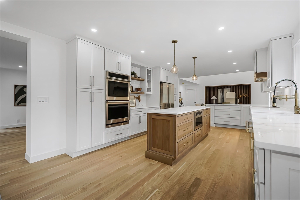 54 Spywood Road Sherborn, MA 01770 - Photo 8 of 41 a large kitchen with a large counter top a sink stainless steel appliances and cabinets