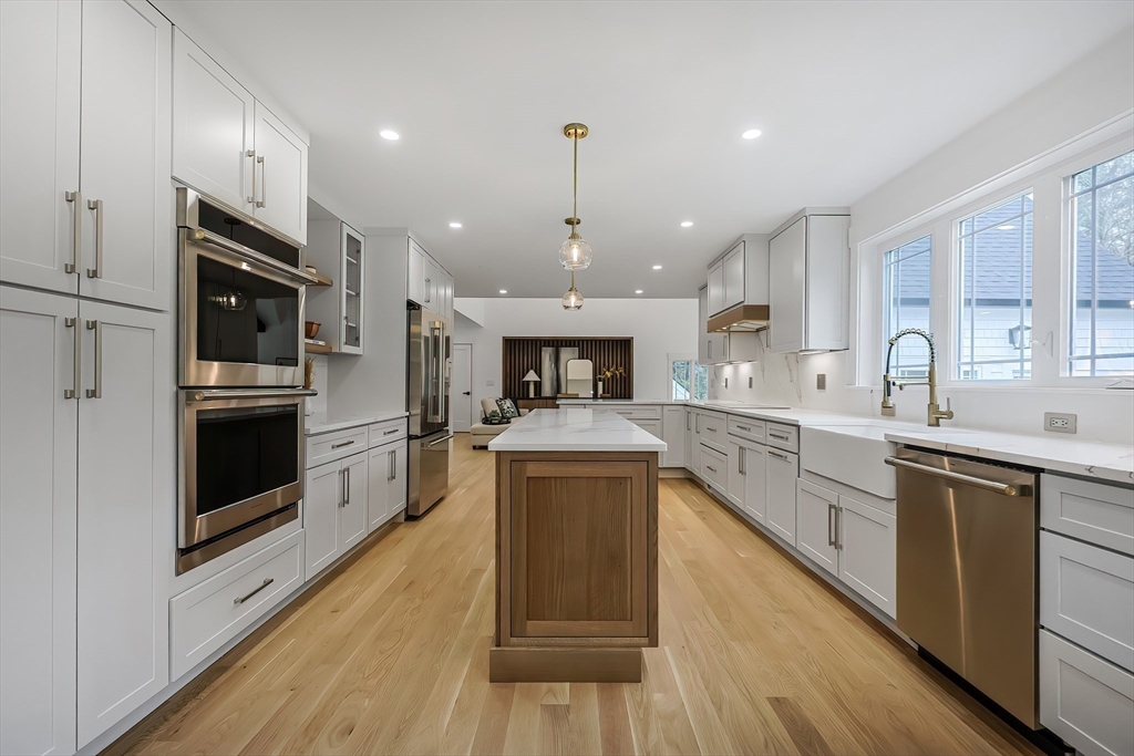 54 Spywood Road Sherborn, MA 01770 - Photo 10 of 41 a large kitchen with stainless steel appliances granite countertop a stove top oven a sink dishwasher a refrigerator and a dining table with wooden floor
