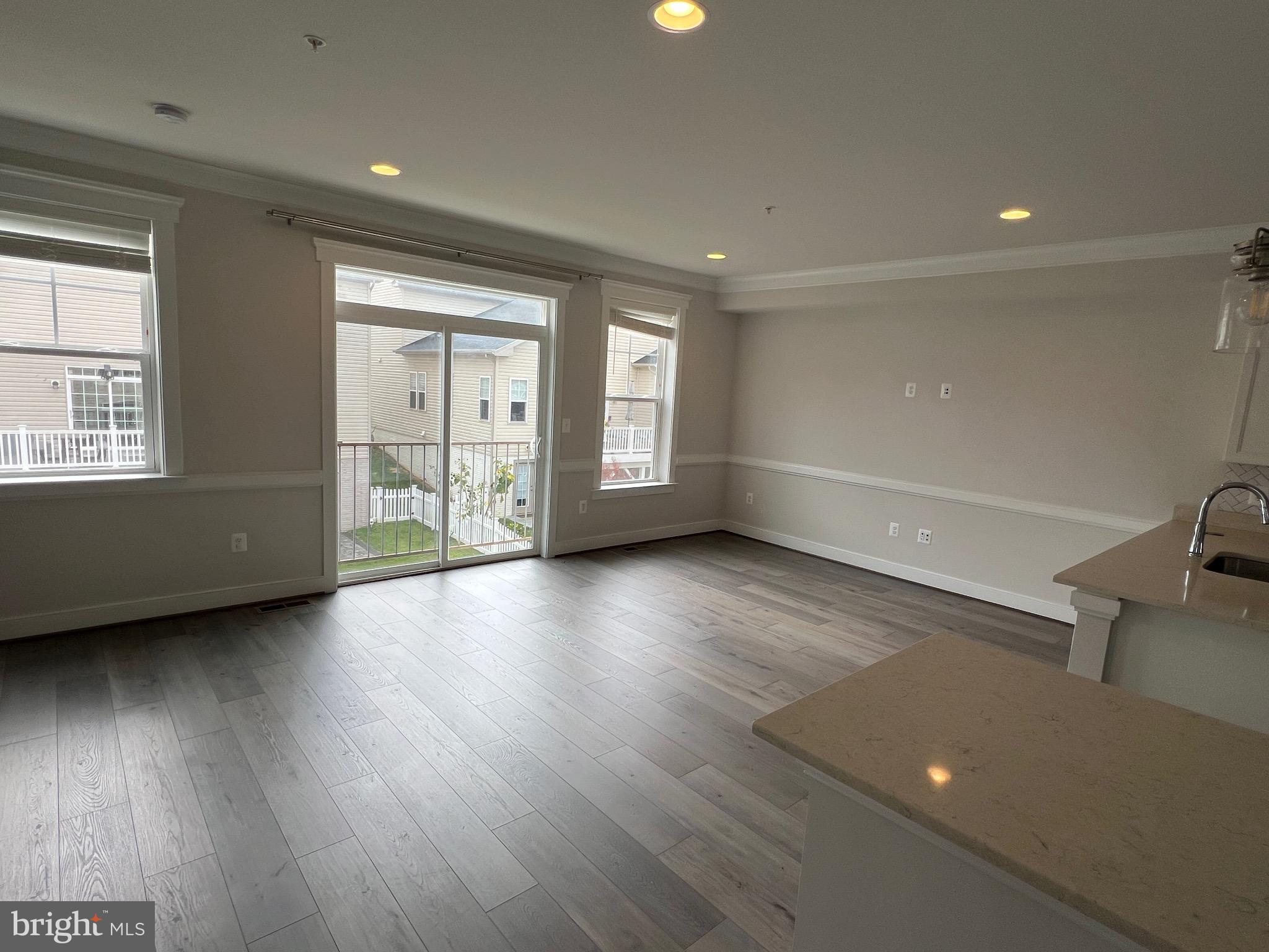 3400 Landing Way Silver Spring, MD 20906 - Photo 12 of 32 an empty room with wooden floor and windows