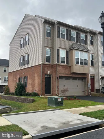 a front view of a house with a yard and a garage