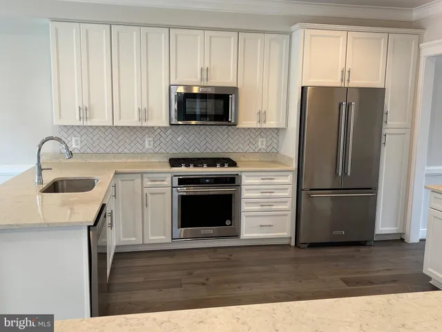 a kitchen with a refrigerator stove and microwave