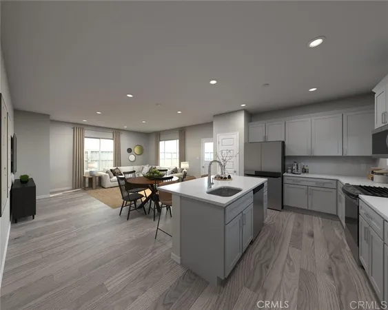a kitchen with a sink and wooden floor