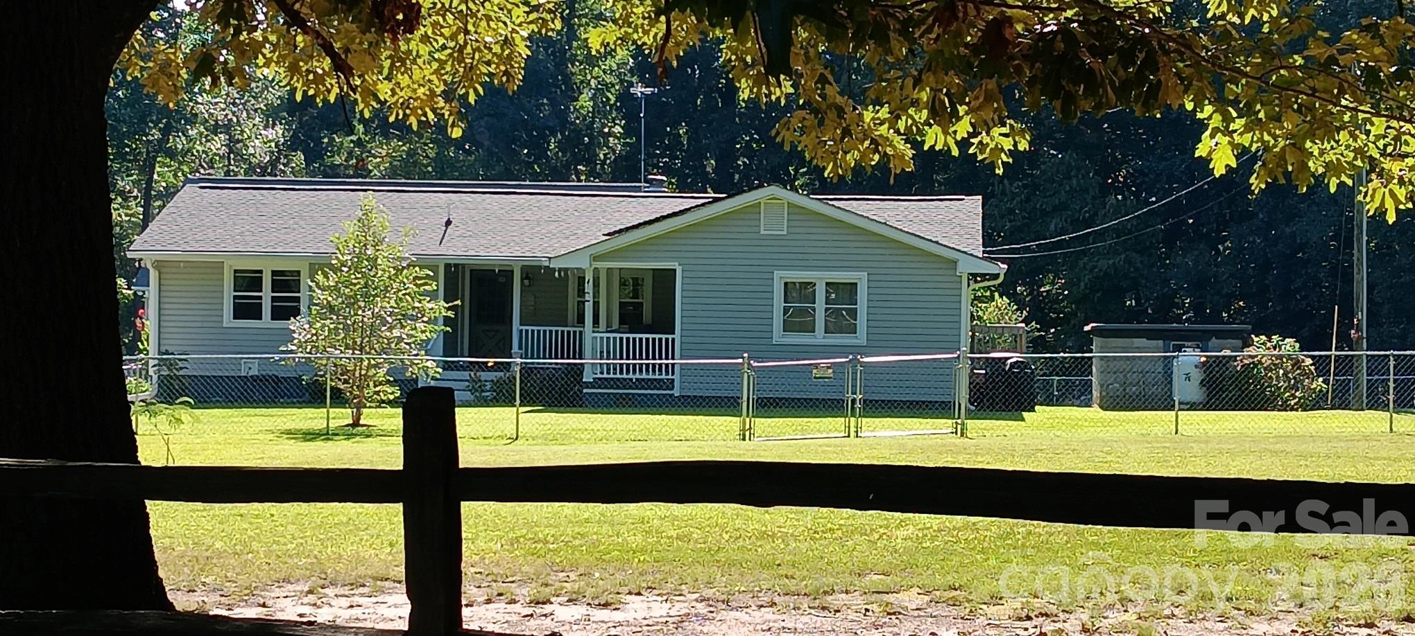 240 Eldon Lane Salisbury, NC 28144 - Photo 1 of 41 a view of swimming pool with seating space and trees in the background