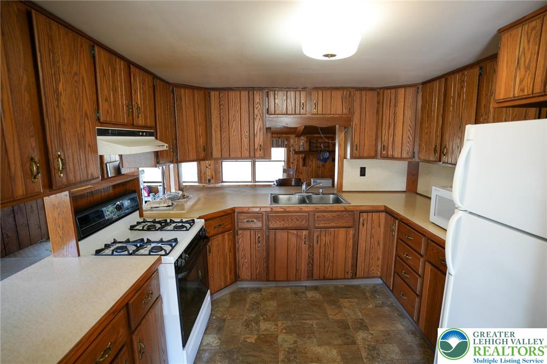 8245 Interchange Road Lehighton, PA 18235 - Photo 11 of 35 a kitchen with stainless steel appliances granite countertop a stove sink refrigerator and cabinets