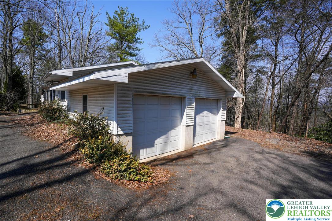 8245 Interchange Road Lehighton, PA 18235 - Photo 8 of 35 a house with a yard and a large tree