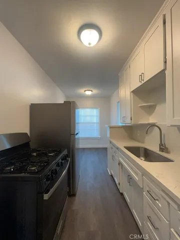 a kitchen that has a sink and a stove