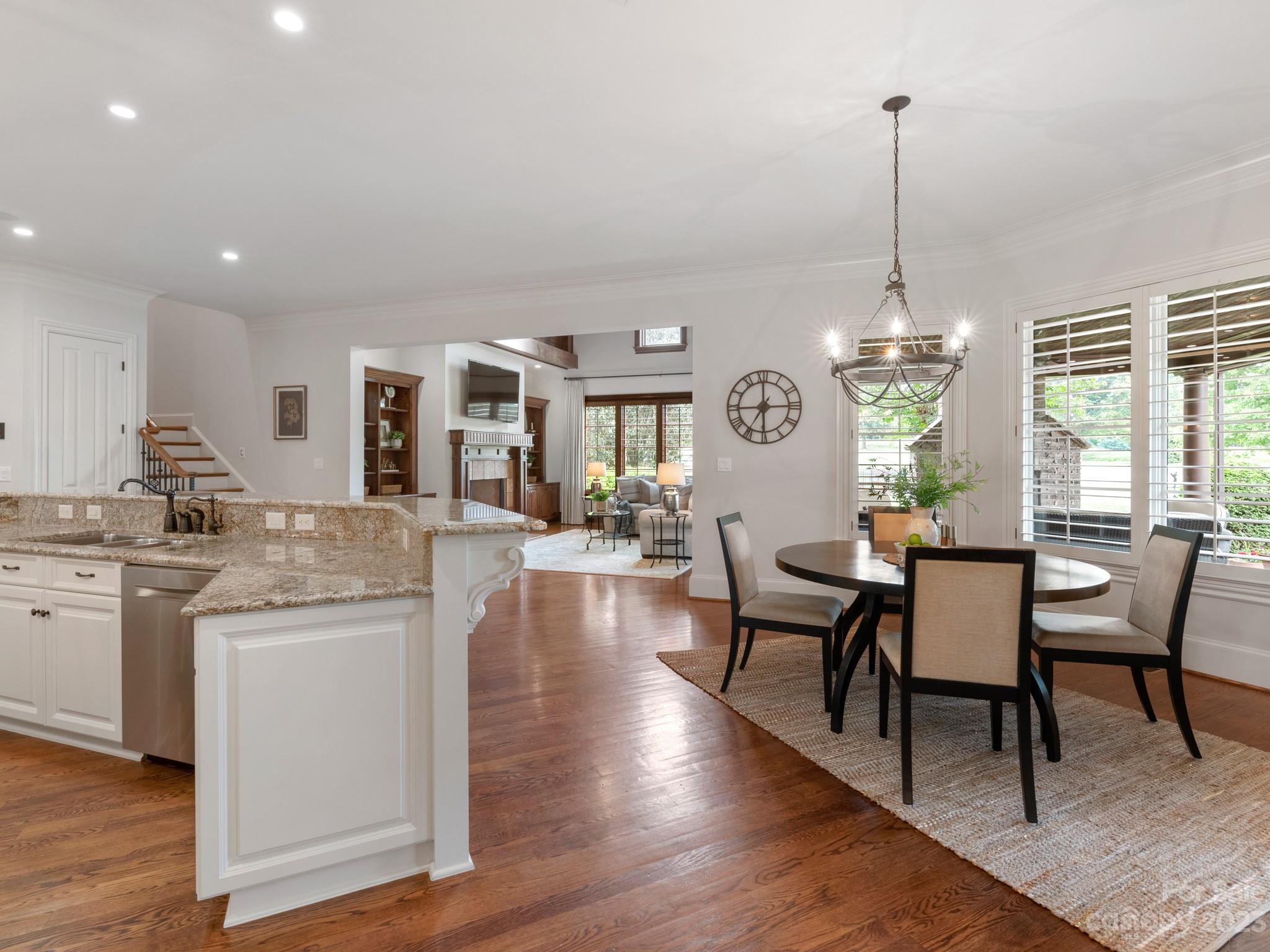 304 Eagle Bend Drive Waxhaw, NC 28173 - Photo 12 of 48 a view of a dining room and livingroom with furniture wooden floor a chandelier