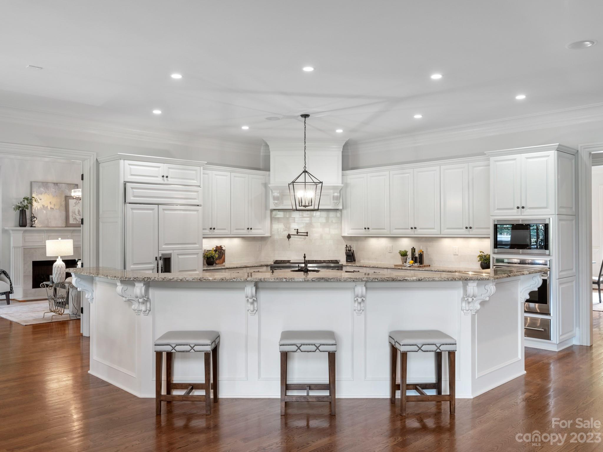 304 Eagle Bend Drive Waxhaw, NC 28173 - Photo 16 of 48 a kitchen with stainless steel appliances granite countertop a stove top oven a sink dishwasher and white cabinets with wooden floor