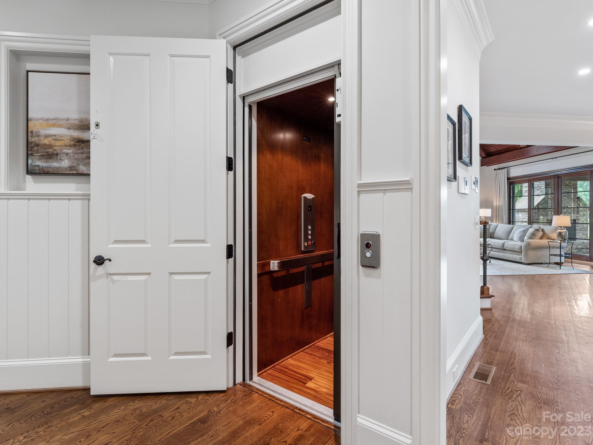 304 Eagle Bend Drive Waxhaw, NC 28173 - Photo 26 of 48 a view of a hallway with wooden floor fireplace and living room