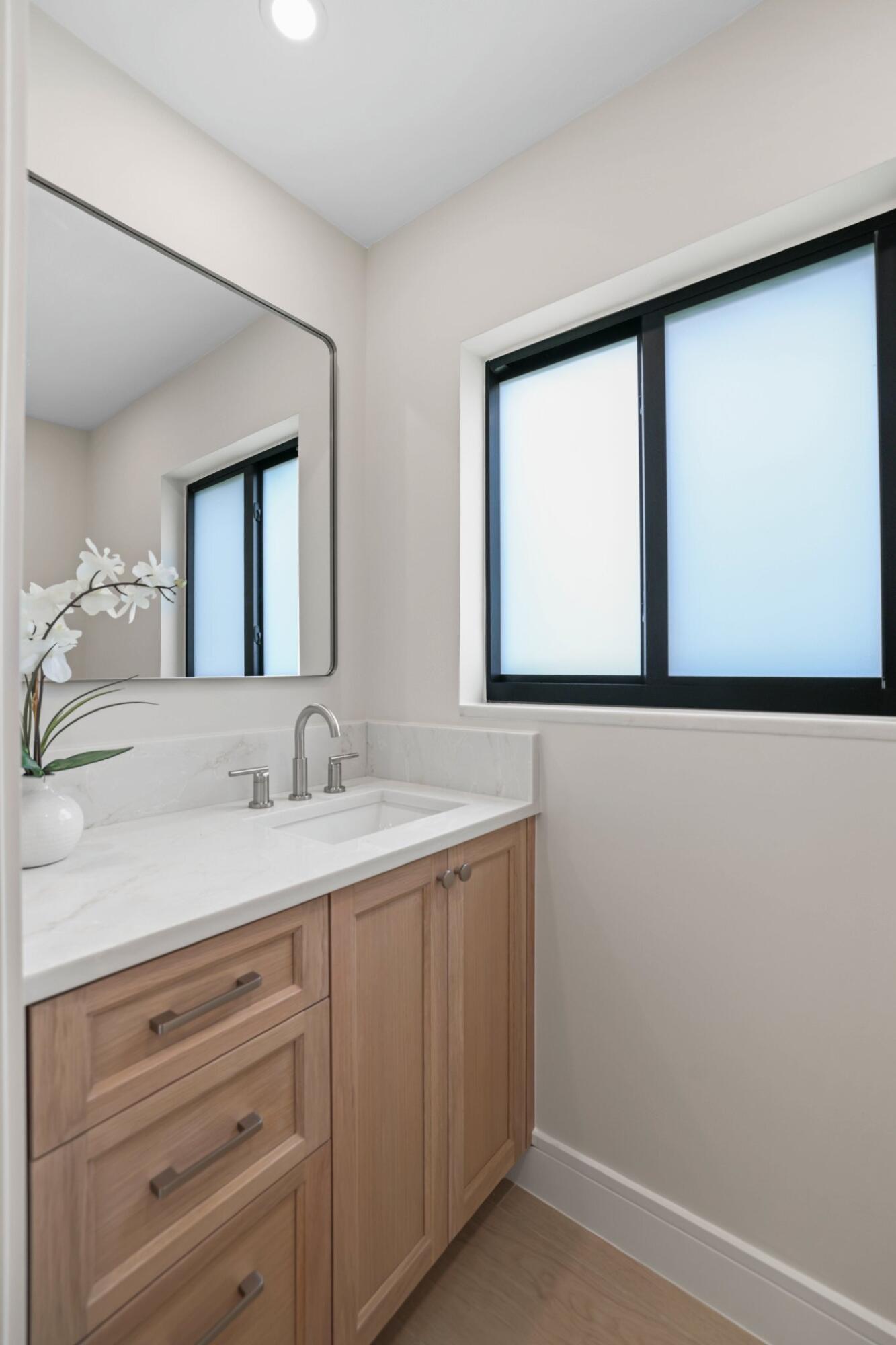 3901 Northwest 27th Avenue Boca Raton, FL 33434 - Photo 29 of 56 a bathroom with a sink and a mirror