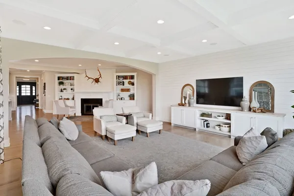 a living room with furniture and large windows