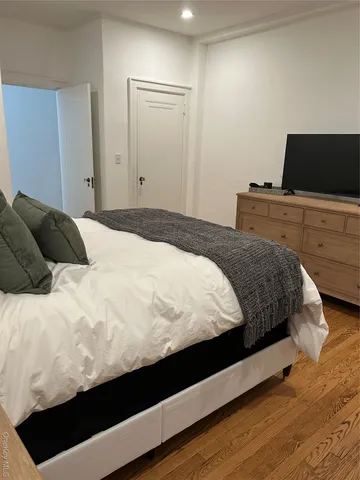 a bedroom with a bed and tv