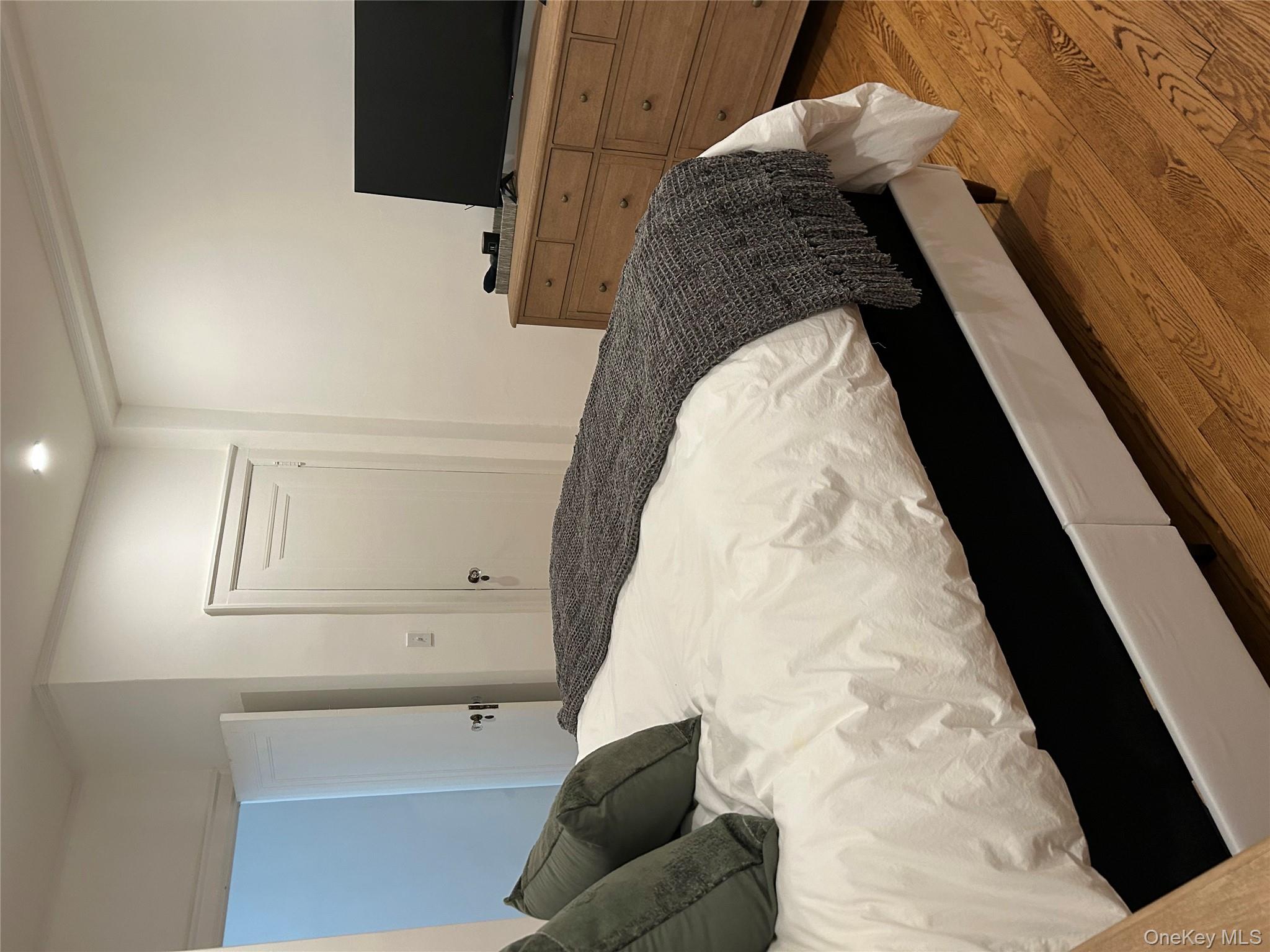 56 Pondfield Road West, Unit 4A Bronxville, NY 10708 - Photo 13 of 22 a bedroom with a bed and tv