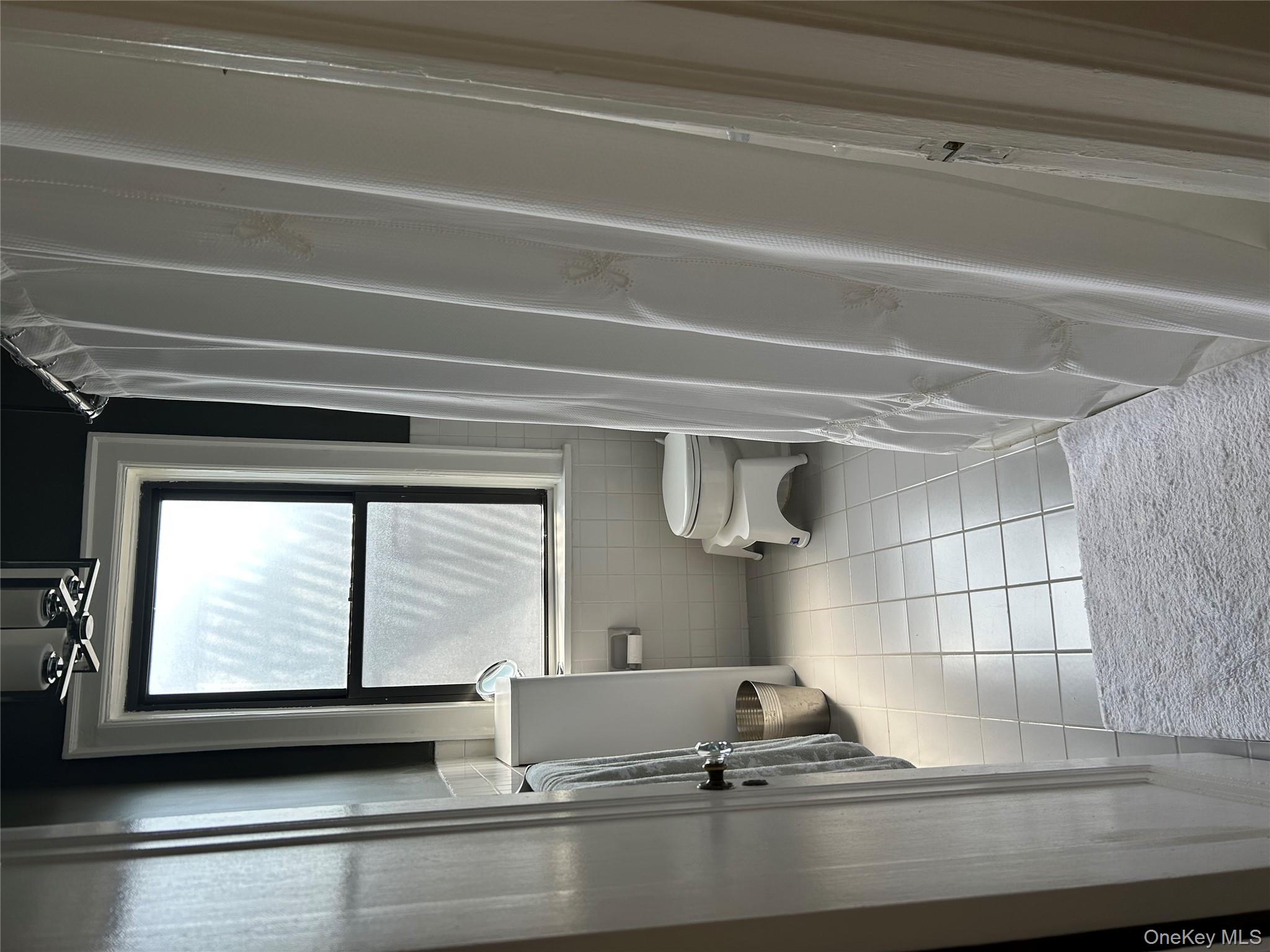 56 Pondfield Road West, Unit 4A Bronxville, NY 10708 - Photo 14 of 22 a bathroom with a window toilet and a shower