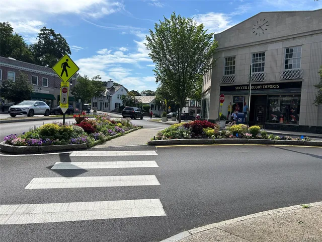 a front view of a house with sitting area and swimming pool