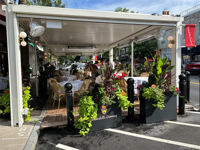 a view of water fountain in front of retail shop