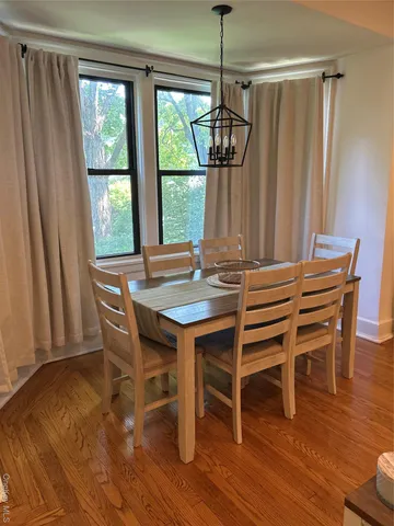 a view of a dining room with furniture window and wooden floor