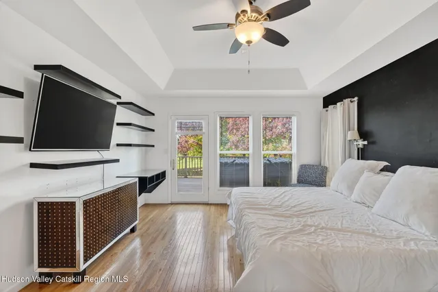 a bedroom with a large bed and a chandelier