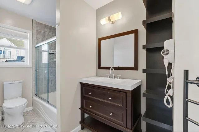 a view of a hallway with wooden floor and windows