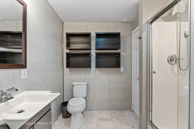 a front view of a house with a yard and potted plants