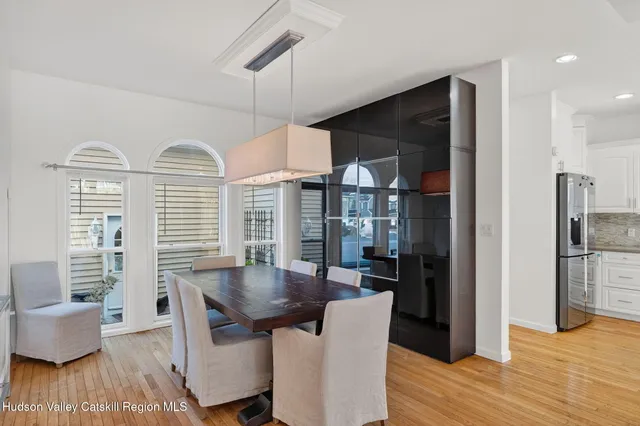 a kitchen with stainless steel appliances kitchen island granite countertop a sink and chairs