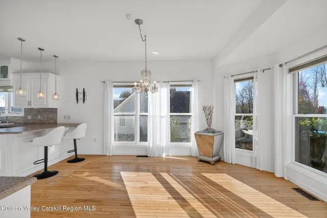 a spacious bedroom with a bed and a flat screen tv