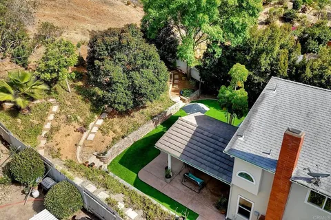 a view of a backyard with sitting area