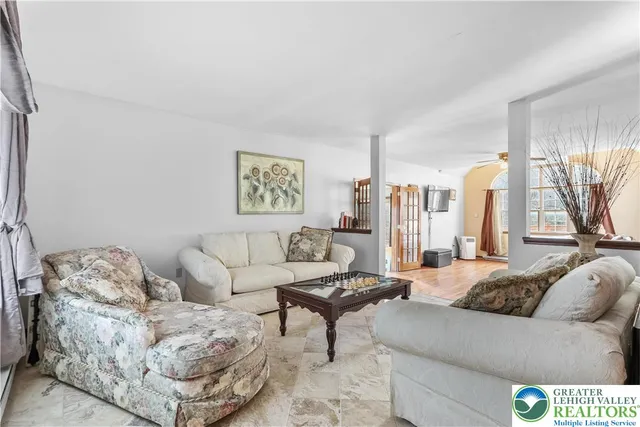 a view of washer and dryer with bathroom in the background