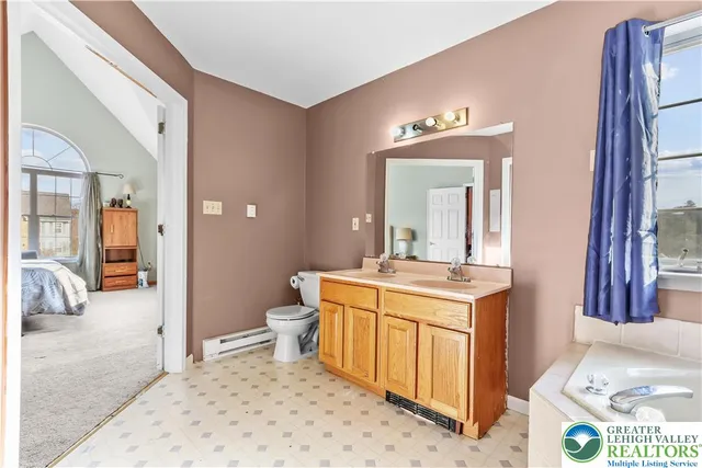 a spacious bedroom with a bed and a couch