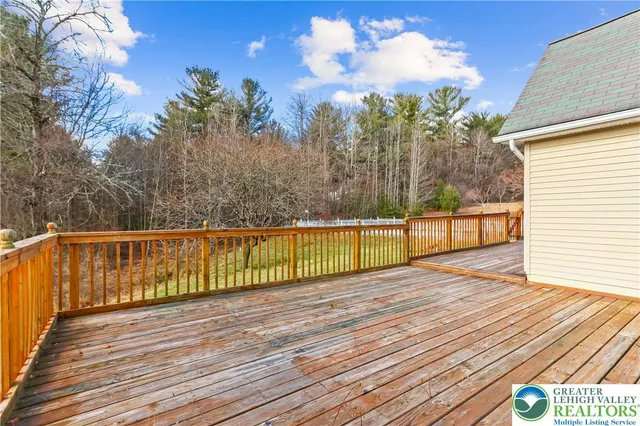 a view of balcony with wooden floor and outdoor seating
