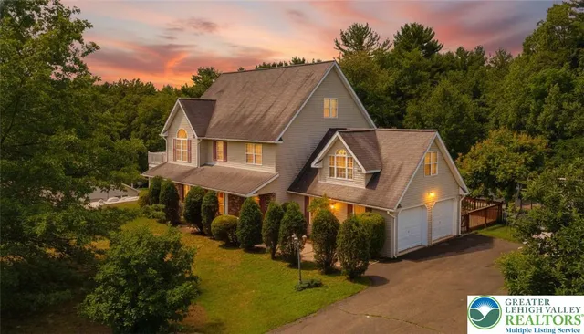an aerial view of a house with swimming pool outdoor seating and yard