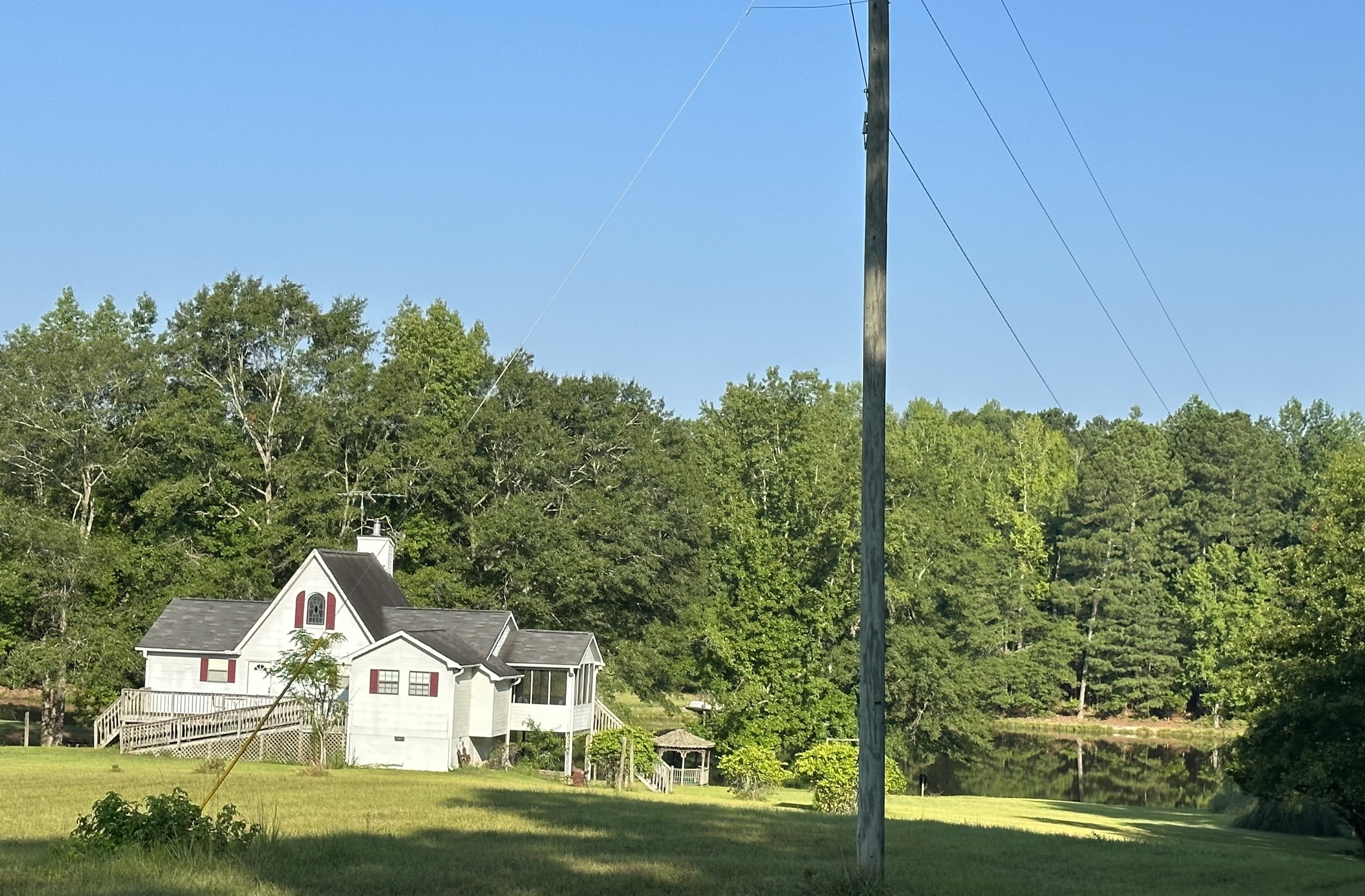 a view of a big house with a big yard and plants