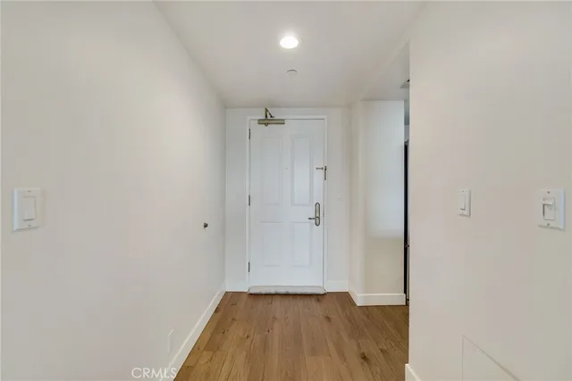 a kitchen with stainless steel appliances granite countertop a sink a stove and a granite counter tops with white walls