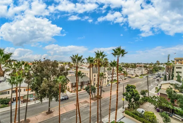 a view of a dining room with furniture a chandelier and wooden floor