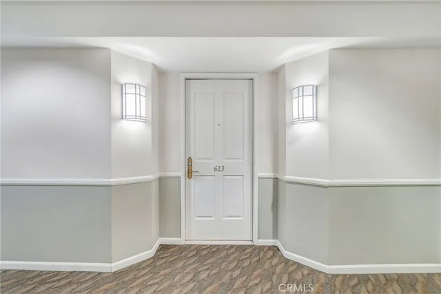 a kitchen with stainless steel appliances a refrigerator a stove a sink and chairs