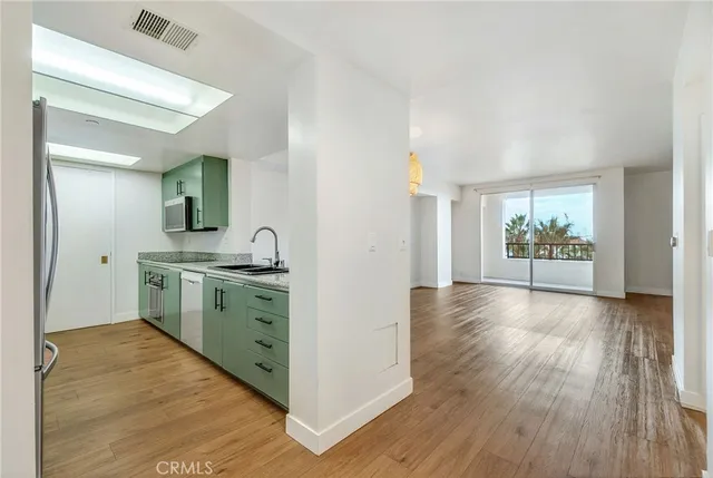 a view of a dining room with furniture wooden floor and chandelier