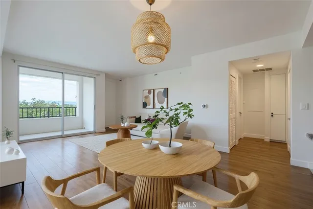 a dining room with furniture and wooden floor