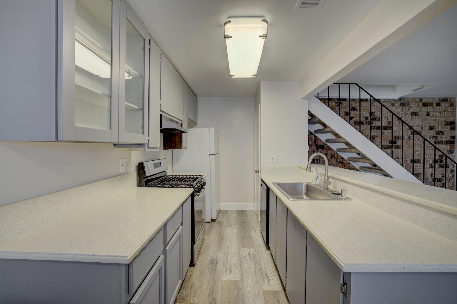 277 Sharp Circle, Unit 2 Roseville, CA 95678 - Photo 12 of 19 a kitchen with stainless steel appliances granite countertop a sink and stove top oven