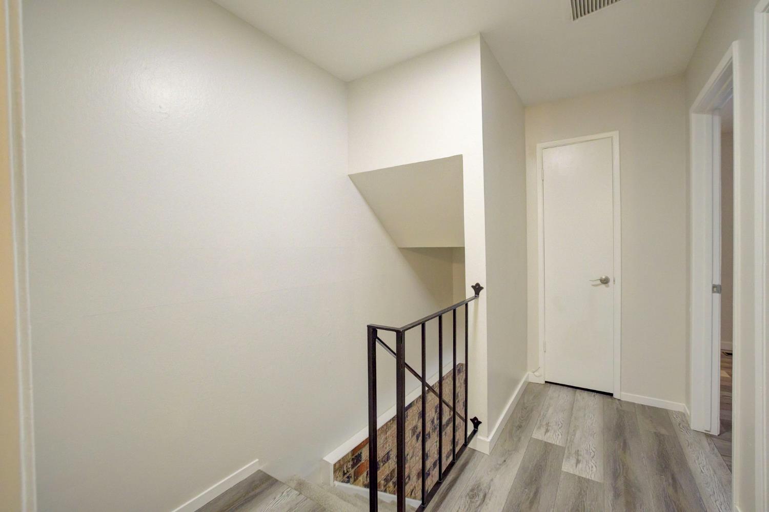 277 Sharp Circle, Unit 2 Roseville, CA 95678 - Photo 14 of 19 a view of a hallway with wooden floor and staircase