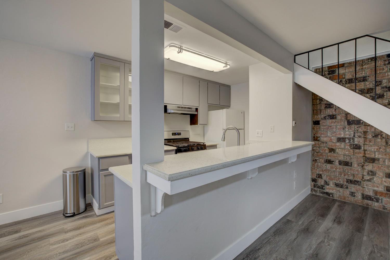 277 Sharp Circle, Unit 2 Roseville, CA 95678 - Photo 10 of 19 a kitchen with a sink cabinets and wooden floor