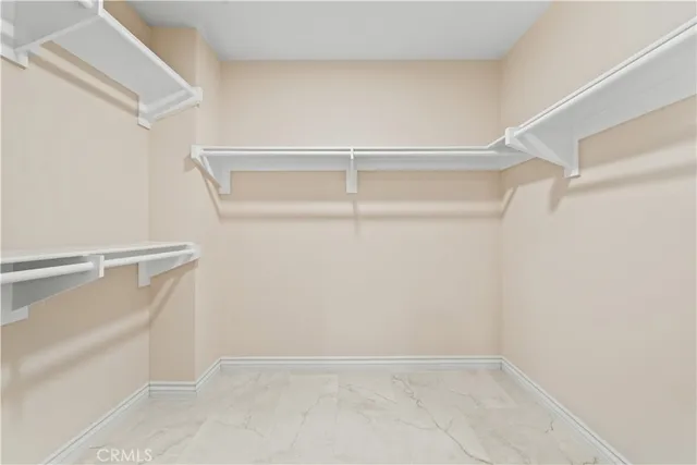 a bathroom with a granite countertop sink a mirror and a shower