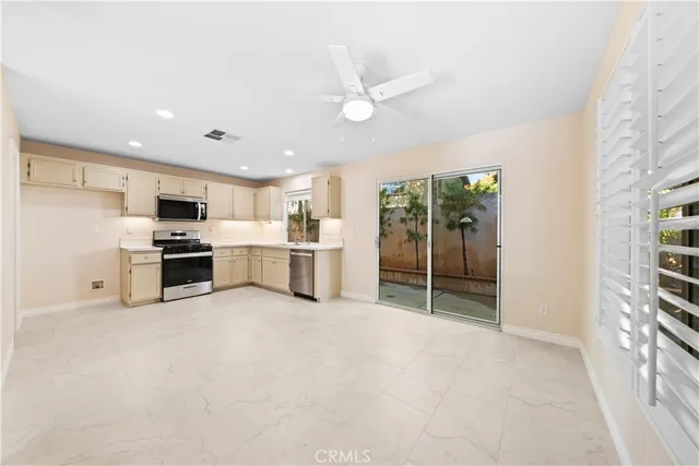 a view of a kitchen with refrigerator and microwave