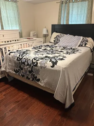 a bed sitting in a bedroom next to a window