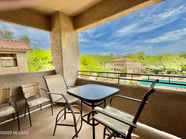 a view of a chairs and table in patio