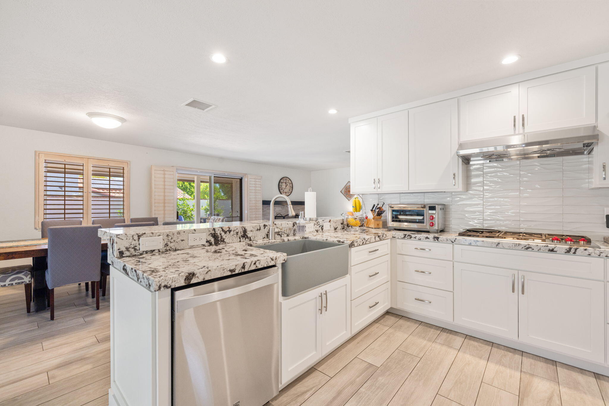 42230 May Pen Road Bermuda Dunes, CA 92203 - Photo 13 of 57 a kitchen with granite countertop white cabinets sink and stove