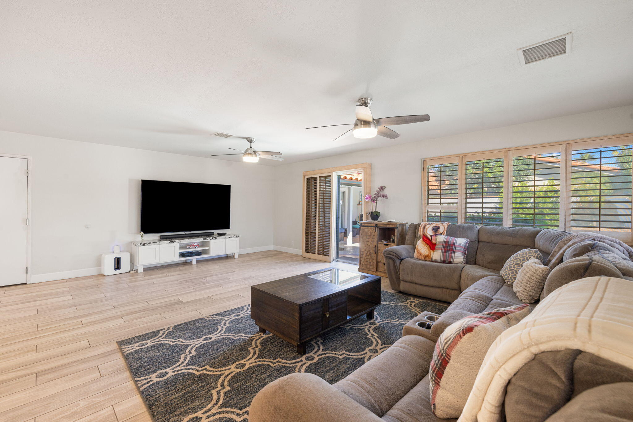 42230 May Pen Road Bermuda Dunes, CA 92203 - Photo 18 of 57 a living room with furniture a flat screen tv and a large window