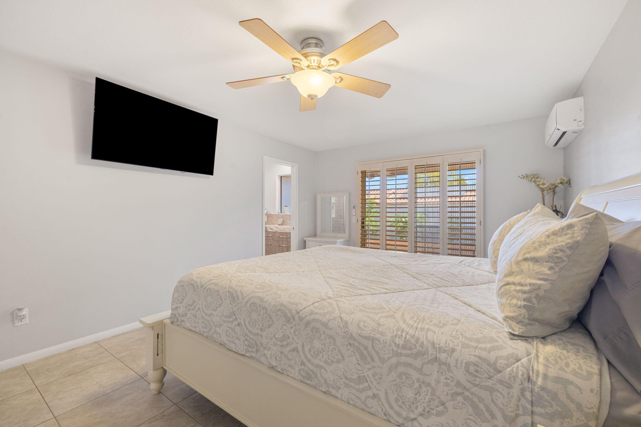 42230 May Pen Road Bermuda Dunes, CA 92203 - Photo 24 of 57 a spacious bedroom with a bed and a flat screen tv