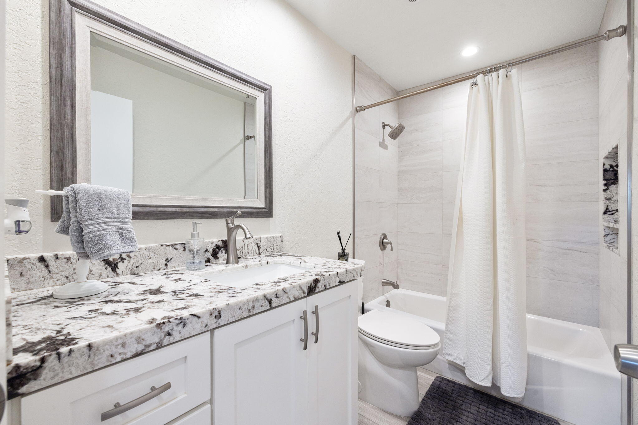 42230 May Pen Road Bermuda Dunes, CA 92203 - Photo 29 of 57 a bathroom with a granite countertop sink toilet a large mirror a shower and a bathtub